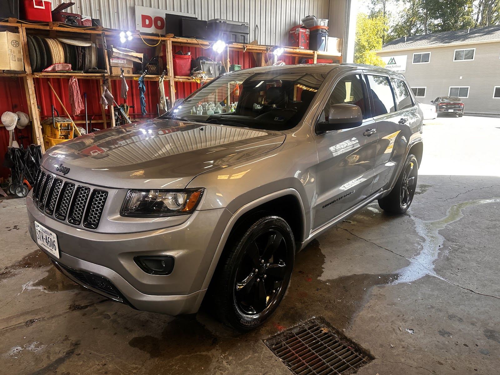 Silver Jeep Grand Cherokee freshly detailed inside the shop